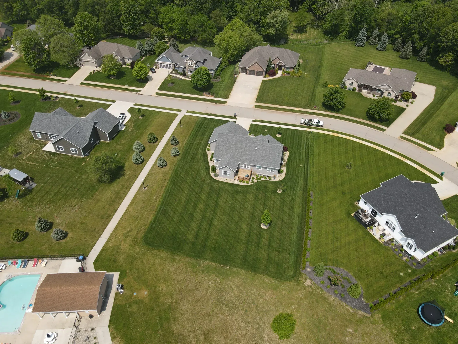 Aerial view of a neighbourhood of homes with GreenWorks-maintained lawns