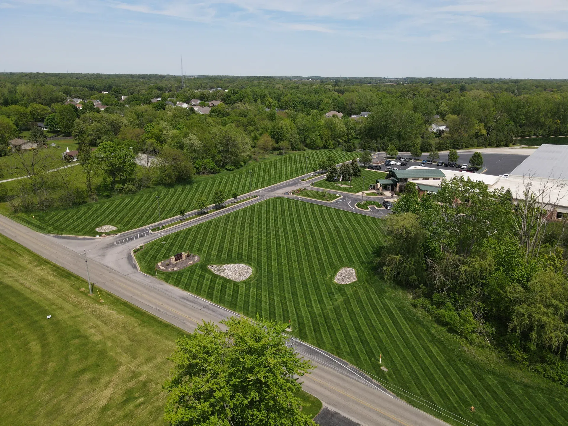 Overhead view of a large striped commercial lawn at the KREMC campus